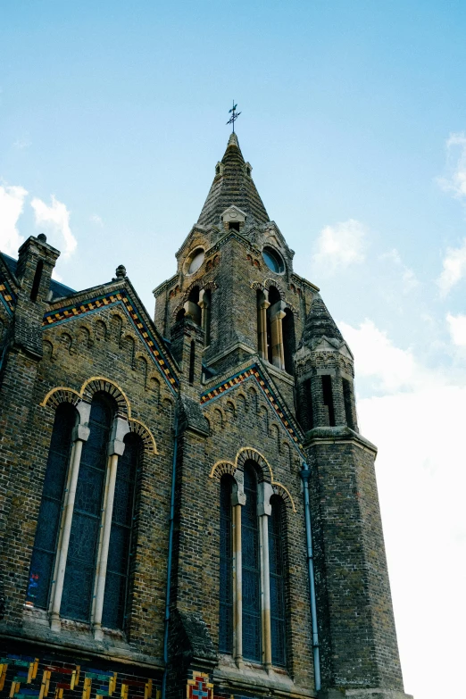 a tall building with a clock on top of it, inspired by Thomas Cornell, trending on unsplash, romanesque, paisley, churches, slate, blue sky above