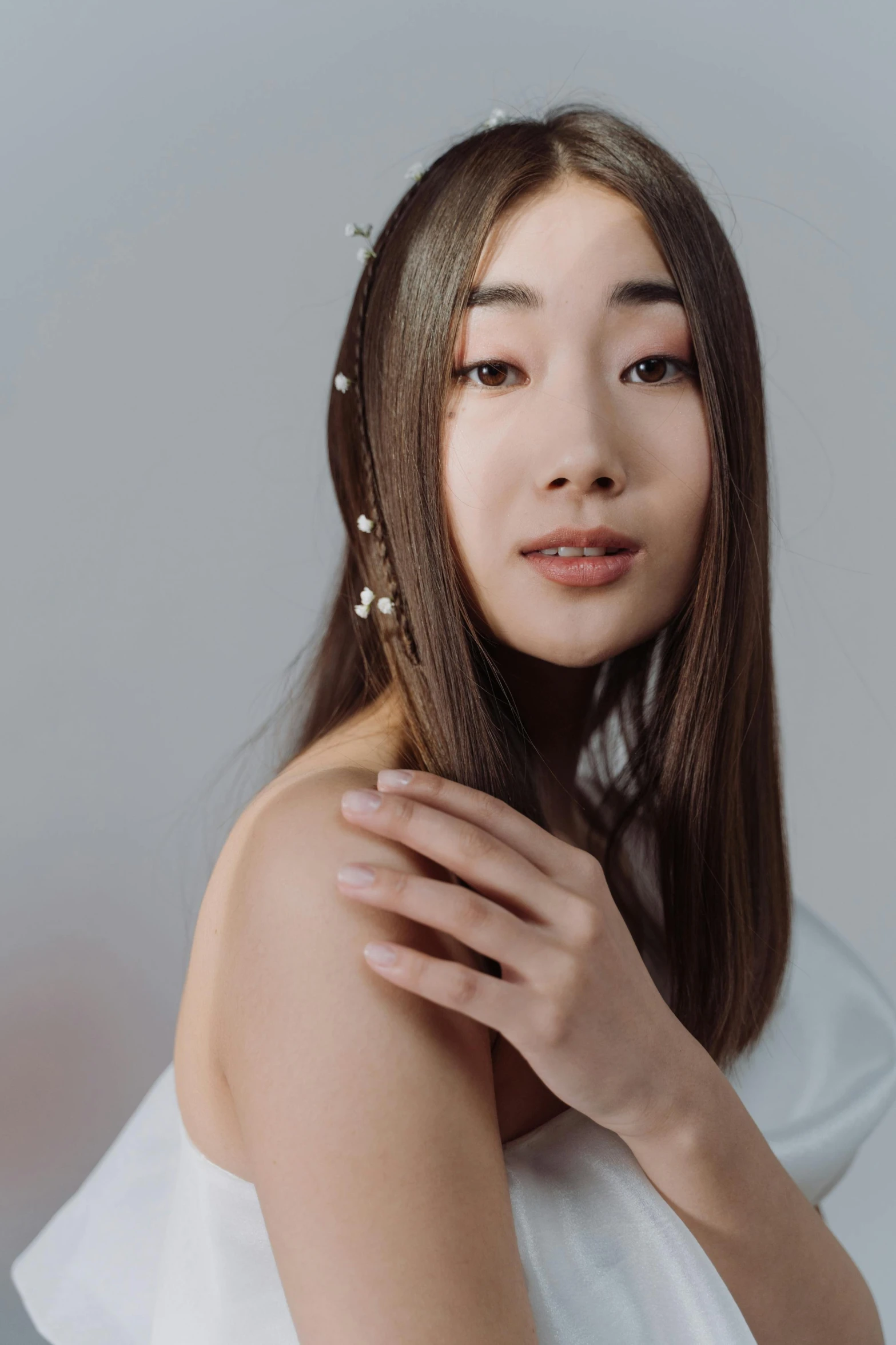 a woman in a white dress posing for a picture, inspired by Kim Tschang Yeul, trending on pexels, realism, smooth hair, pearls, ethnicity : japanese, studio shoot