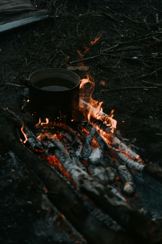 a pot sitting on top of an open fire, by Elsa Bleda, pexels contest winner, hurufiyya, burned forest, bitches brew, album cover, soup