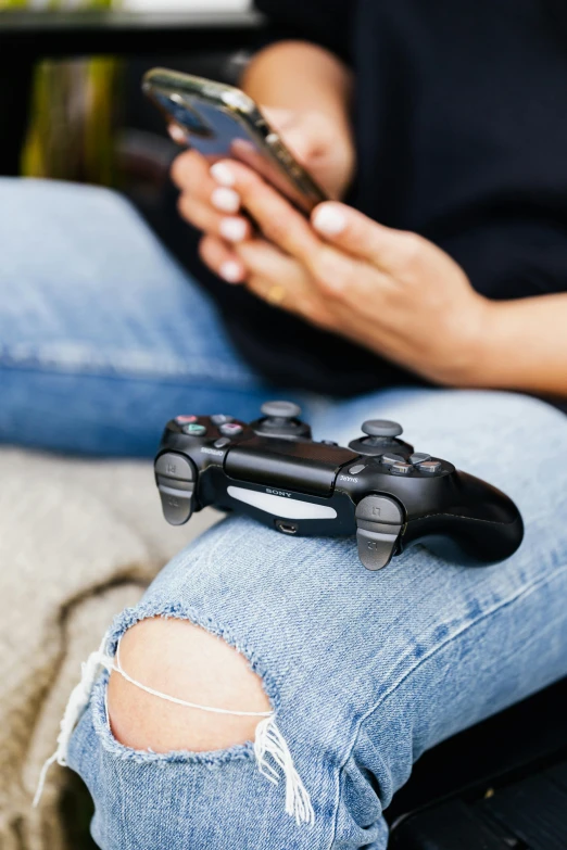 a woman sitting on a couch holding a game controller, sitting on the ground, instagram picture, digital still, playstation