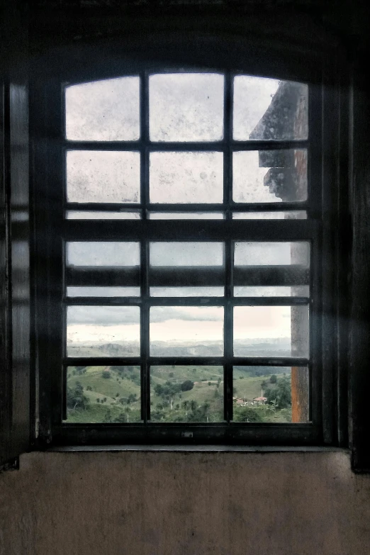 a close up of a window with a view of a field, an album cover, inspired by Thomas Struth, renaissance, lookout tower, window ( rain ), 1 7 9 5, black windows