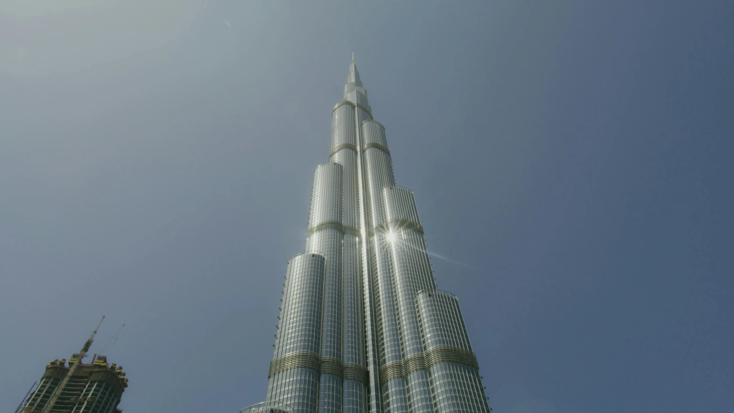 a tall building in the middle of a city, dubai, fan favorite, raytracing on, monumental structures