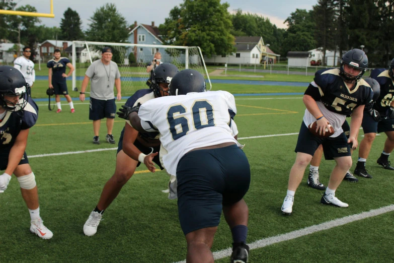 a group of young men playing a game of football, an album cover, unsplash, navy, pitt, summer day, low quality photo