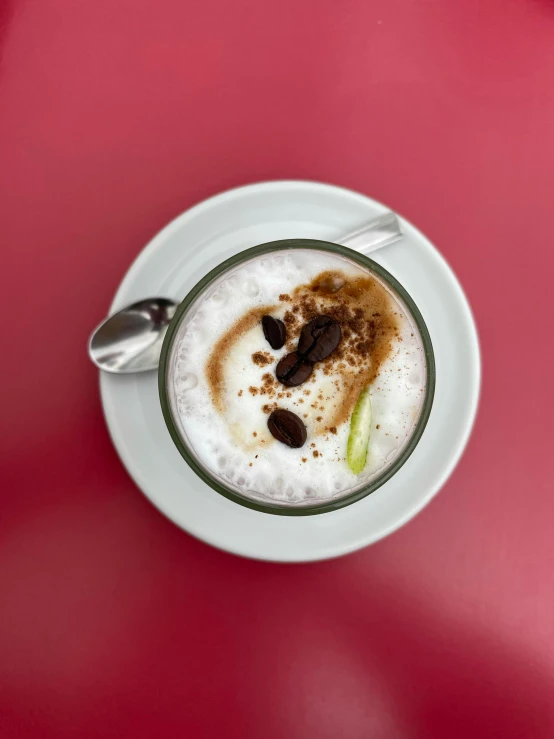 a cup of coffee sitting on top of a red table, yogurt, thumbnail, elaborate, top - down