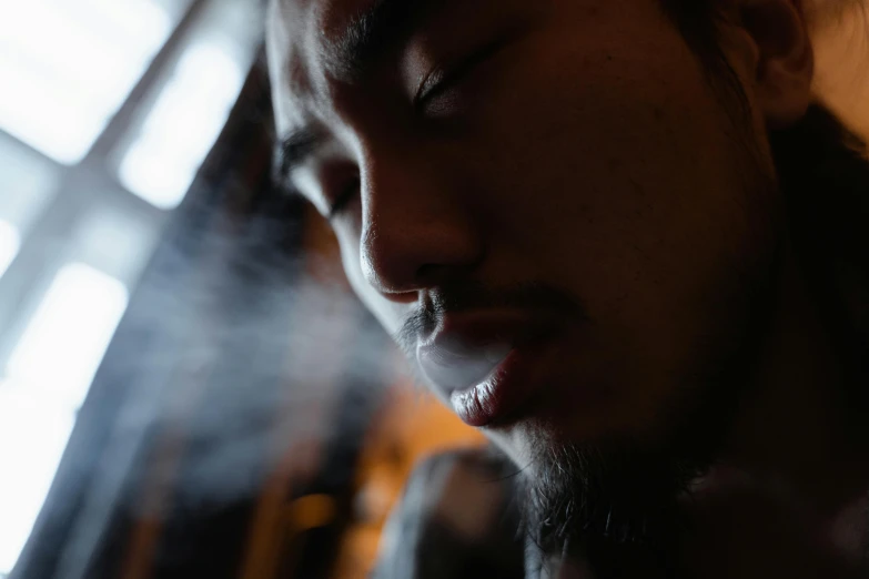 a close up of a person smoking a cigarette, inspired by Zhu Da, pexels contest winner, ethnicity : japanese, sleepy expression, 4 2 0, portrait soft low light