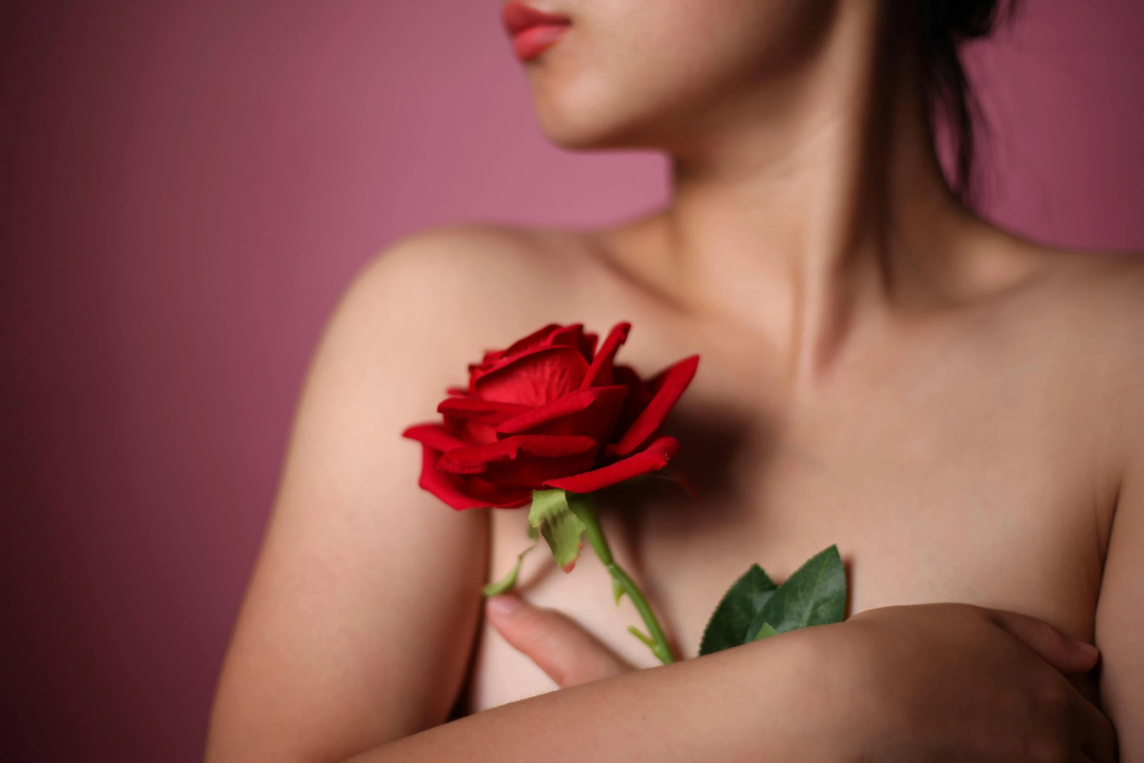 a woman with a rose in her hand, trending on pexels, red bra, smooth pink skin, in style of robert mapplethorpe, mai anh tran