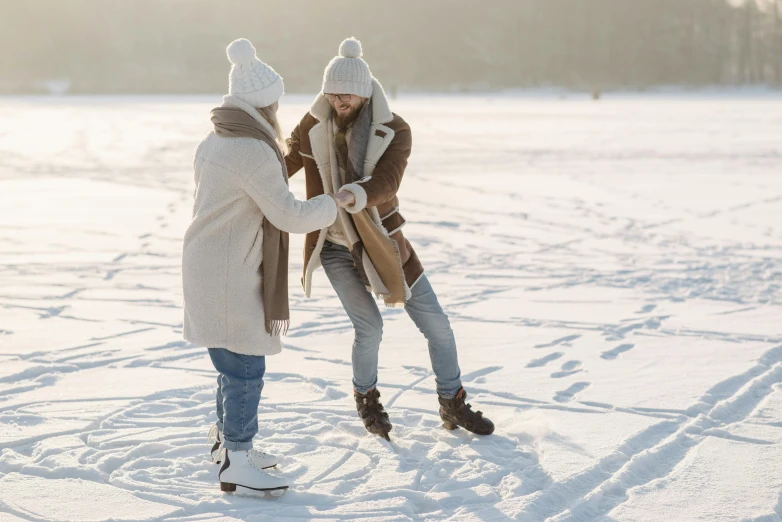 a couple of people standing on top of a snow covered field, roller skating, hygge, brown, tan