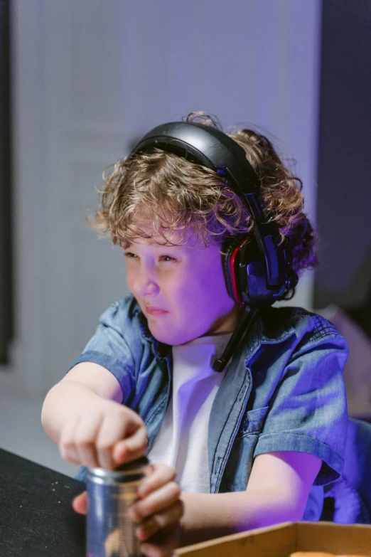 a young boy sitting at a table with headphones on, happening, team ibuypower, artsation, thumbnail, profile picture 1024px