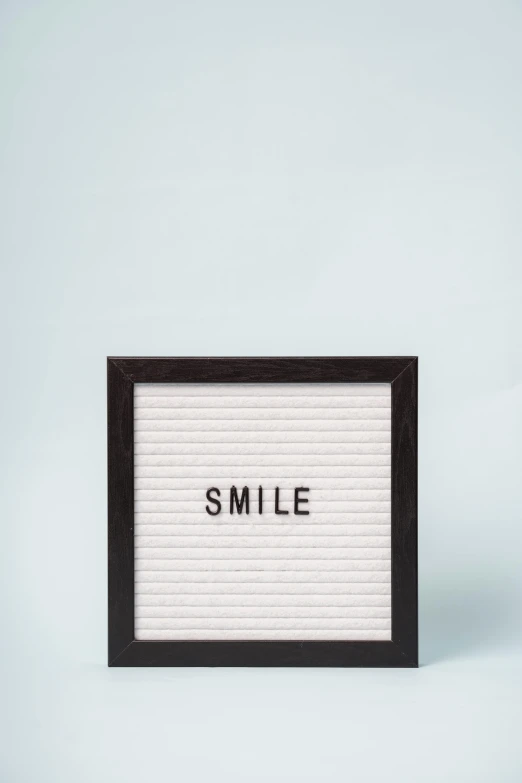 a letter board with the word smile on it, by Harvey Quaytman, minimalism, picture frames, whiteboards, picture