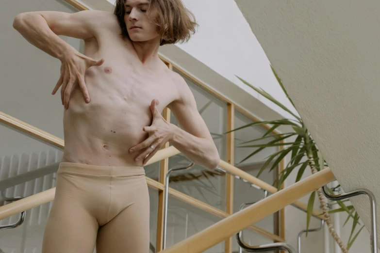 a man that is standing on some stairs, wearing leotard, translucent skin, male emaciated, thumbnail