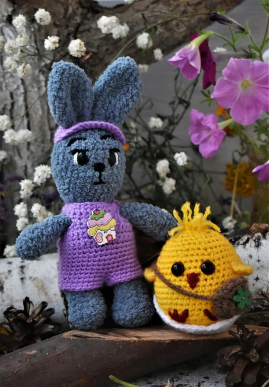 a couple of stuffed animals sitting next to each other, purple and yellow, spring theme, thumbnail, crochet