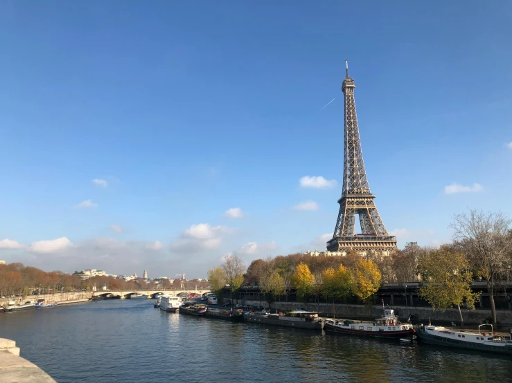 a view of the eiffel tower from across the river, a photo, pexels contest winner, paris school, clear blue skies, 🦩🪐🐞👩🏻🦳, 8k”, february)