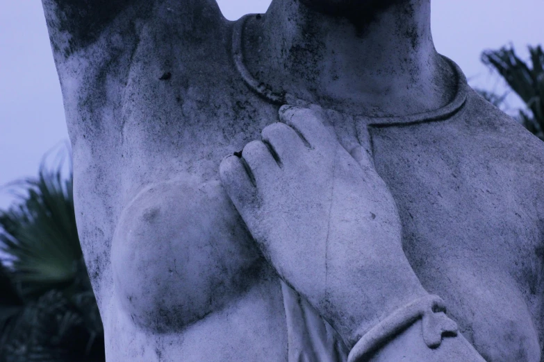 a statue of a man with his hands on his chest, unsplash, romanticism, blue and grey, decollete, taken in the late 2000s, indigo