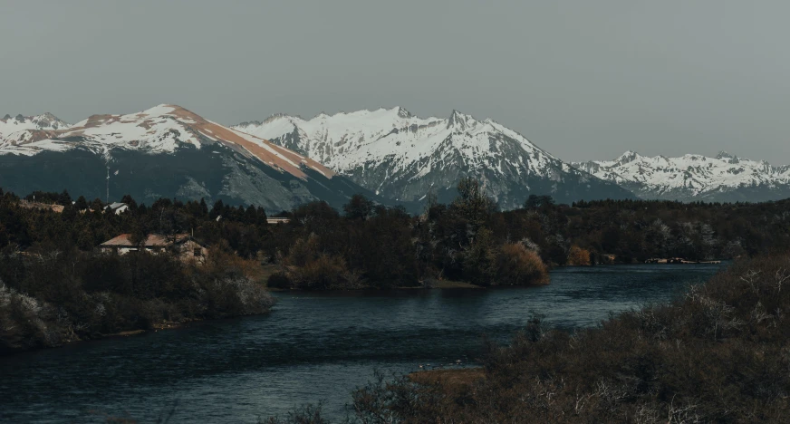 a river running through a forest filled with snow covered mountains, unsplash contest winner, hurufiyya, obsidian towers in the distance, 4 k hd wallpapear, small town surrounding, grey