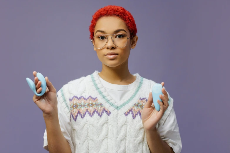 a woman with red hair holding a pair of scissors, inspired by Jean-Étienne Liotard, trending on pexels, mixed race, tamagotchi, ice blue, square glasses