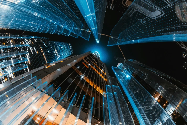 a group of tall buildings in a city at night, digital art, by Adam Marczyński, pexels contest winner, dimensional cyan gold led light, low angle fisheye view, glass ceilings, tall metal towers