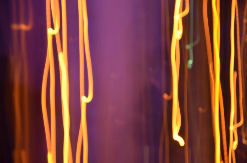 a bunch of lights that are on a wall, unsplash, lyrical abstraction, orange and purple electricity, abstract claymation, connected with glowing tubes 8 k, golden dappled dynamic lighting