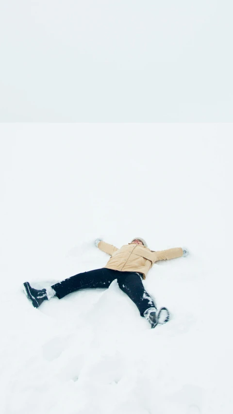 a person laying in the snow on a snowboard, by Ren Hang, trending on unsplash, happy kid, thumbnail, low quality photo, bjarke ingels