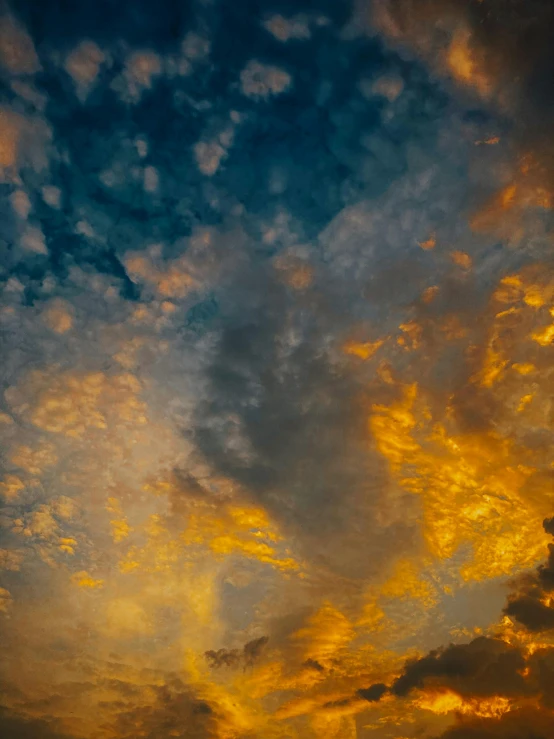 a large body of water under a cloudy sky, a picture, unsplash, romanticism, dappled golden sunset, color ( sony a 7 r iv, may)