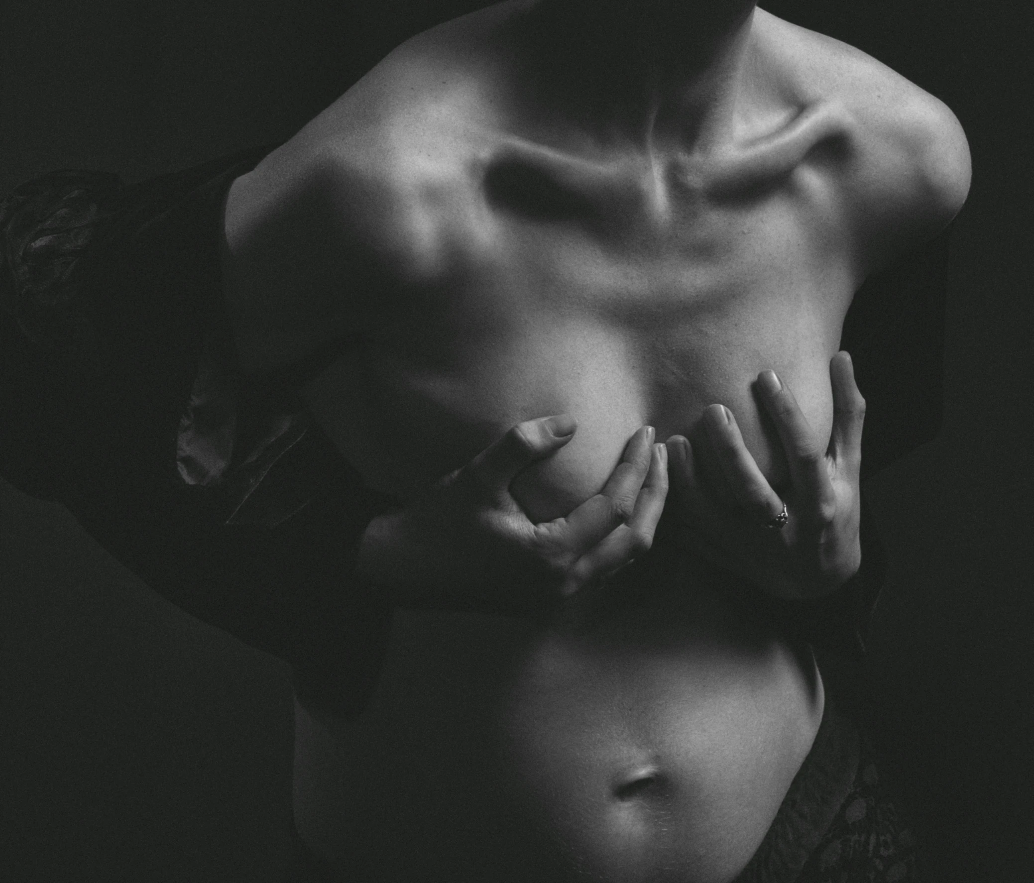 a black and white photo of a pregnant woman, by Matija Jama, unsplash, figurative art, chest coverd, with fingers, set photo, studio medium format photograph