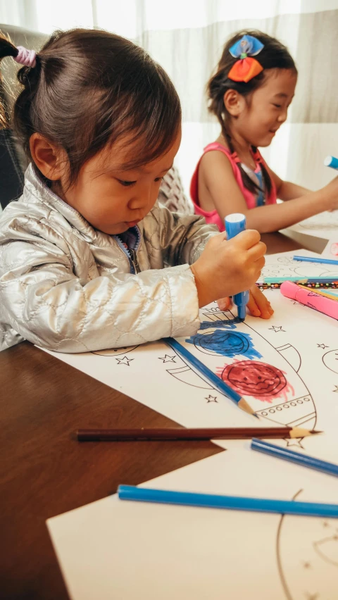 a couple of kids that are sitting at a table, a child's drawing, by Juan O'Gorman, pexels contest winner, process art, drawing an arrow from his quiver, rendering a blue rose, do hoang tuong artwork, educational supplies