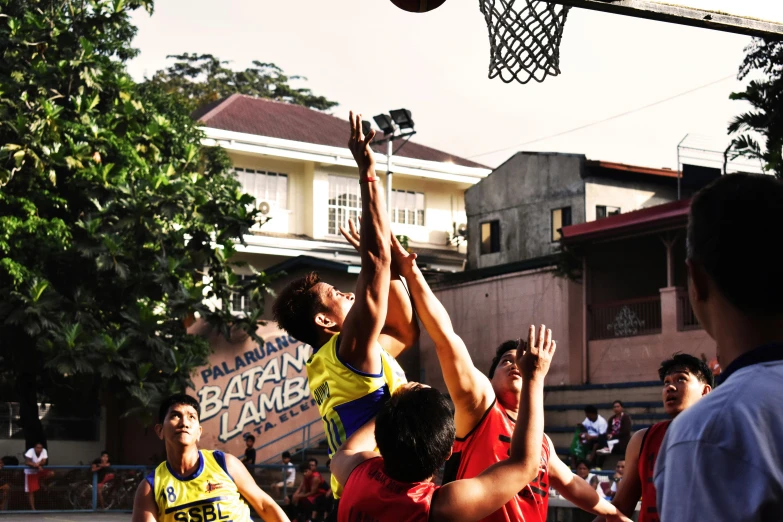 a group of young men playing a game of basketball, a picture, pexels contest winner, cindy avelino, half-body shot, sleeveless, hanging