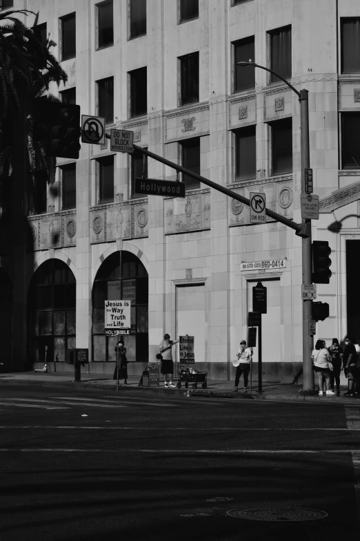 a black and white photo of a city street, a black and white photo, inspired by Garry Winogrand, realism, los angeles 2 0 1 5, street corner, old building, photo from the 80s