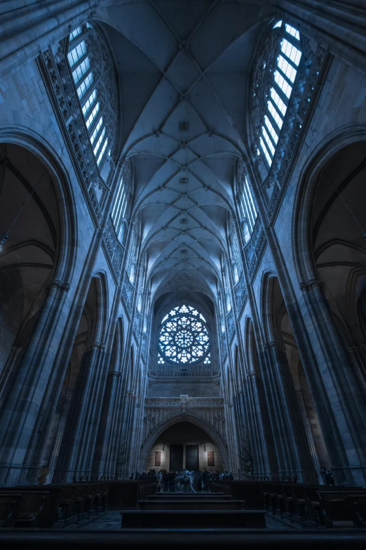 the interior of a cathedral with stained glass windows, a detailed matte painting, unsplash contest winner, gothic art, prague, moody blue lighting, detailed symmetry, skylights