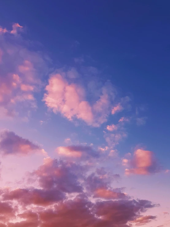 a large clock tower sitting on top of a lush green field, an album cover, trending on unsplash, aestheticism, fluffy pink anime clouds, blue sunset, ☁🌪🌙👩🏾, purple aethetic