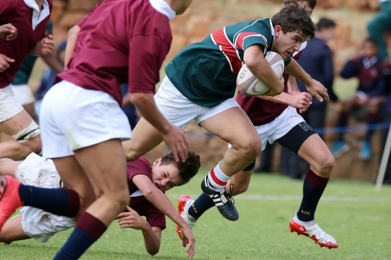 a group of men playing a game of rugby, pexels contest winner, maroon and white, teenage boy, knees upturned, profile pic