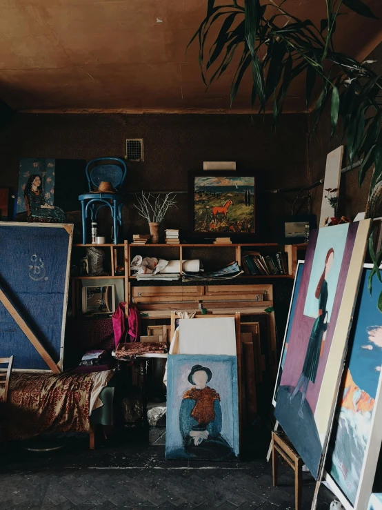 a room filled with lots of art and paintings, by Julia Pishtar, trending on unsplash, studio portrait, van gogh style, in a workshop, high quality picture