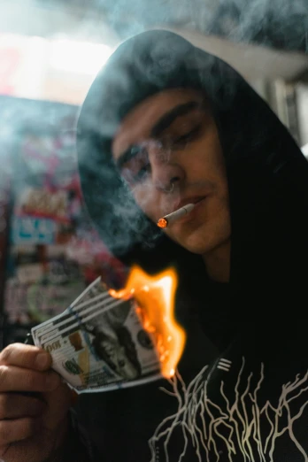 a man that is holding some money in his hand, by Niko Henrichon, pexels contest winner, hyperrealism, casting fire spell, yung lean, wearing a dark hood, hunter biden smoking crack