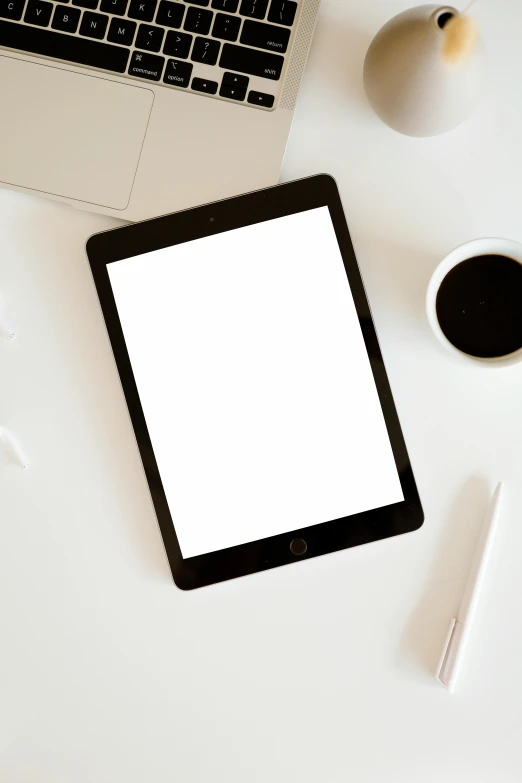 a tablet computer sitting on top of a white table, by Carey Morris, pexels, computer art, square, black, milk, update