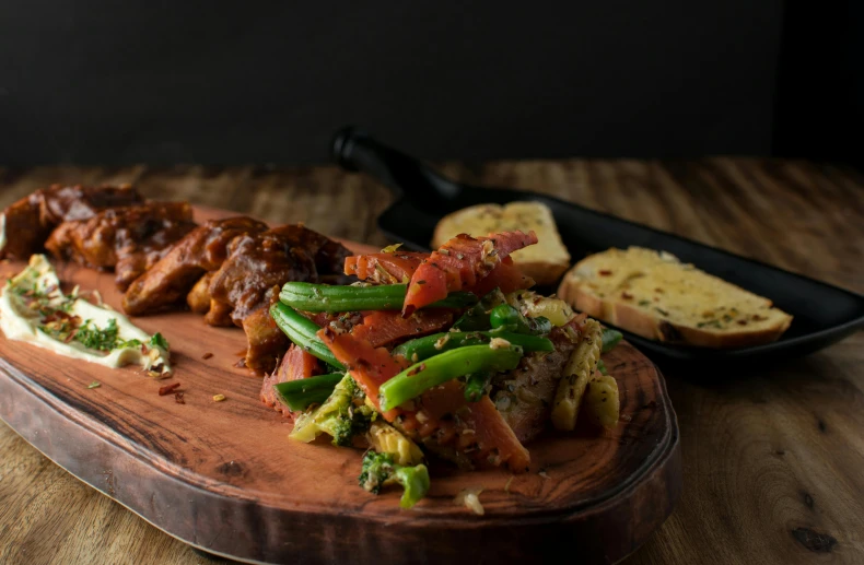 a wooden cutting board topped with meat and vegetables, by Adam Marczyński, lobster, far away shot, stew, dynamic angled shot