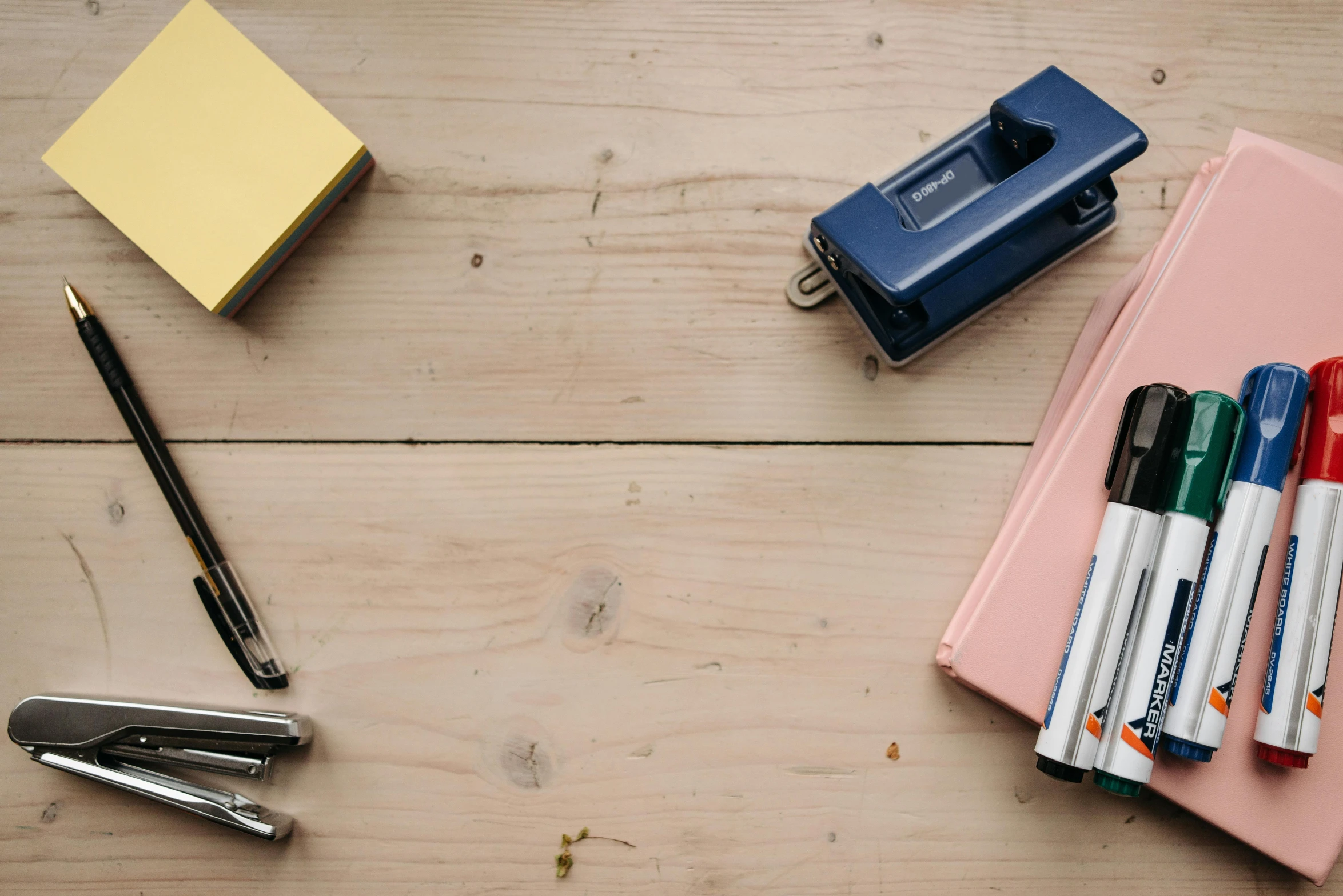 a bunch of pens sitting on top of a wooden table, a still life, trending on pexels, vhs artefacts, background image, 9 9 designs, student