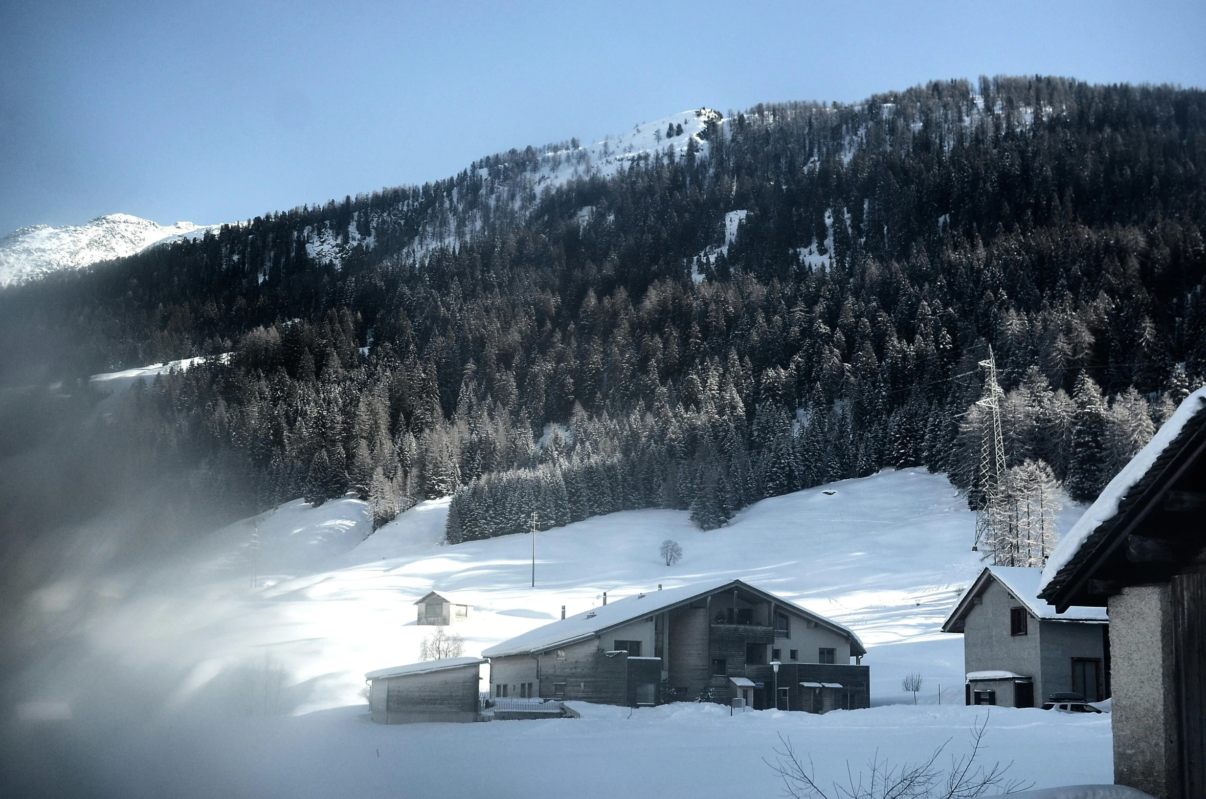 a snow covered mountain with a house in the foreground, inspired by Peter Zumthor, pexels contest winner, les nabis, white steam on the side, against the backdrop of trees, overview, various posed