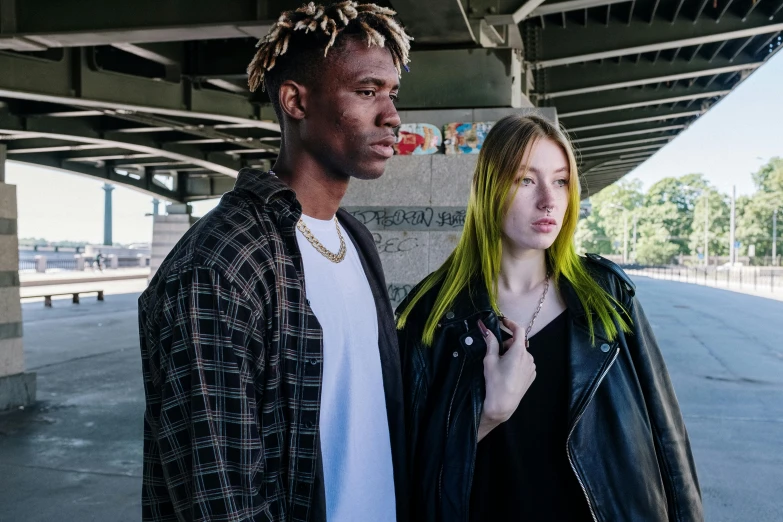 a man and a woman standing next to each other, trending on pexels, antipodeans, black and green, woman in streetwear, greasy hair, thin young male