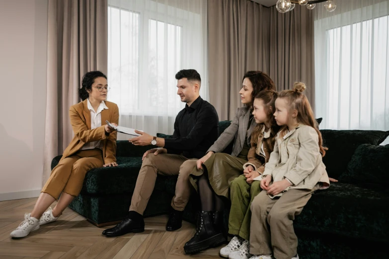 a group of people sitting on a couch in a living room