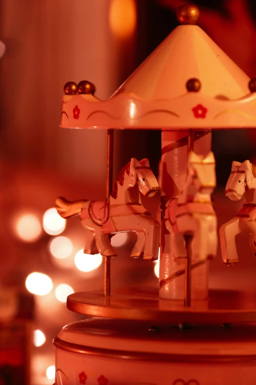 a wooden carousel sitting on top of a table, by Jesper Knudsen, warm glow from the lights, festive, toys, profile image