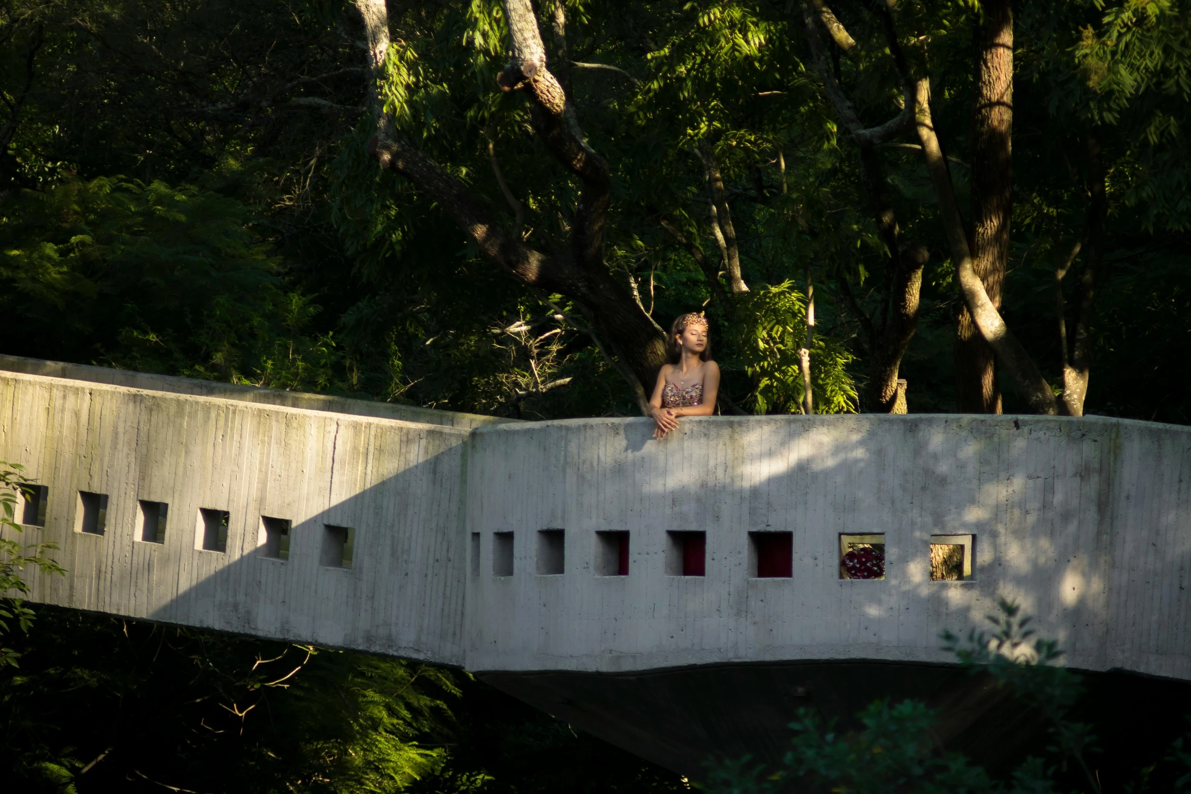 a person standing on a bridge with trees in the background, brutalism, shan shui, architecture photo, resting, wētā fx