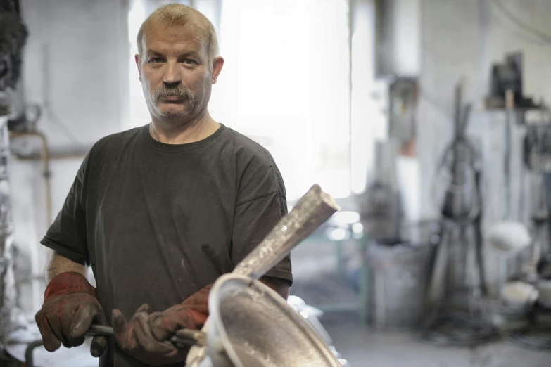 a man holding a piece of metal in his hands, a portrait, arbeitsrat für kunst, foundry vtt, profile image, trending photo, looking smug