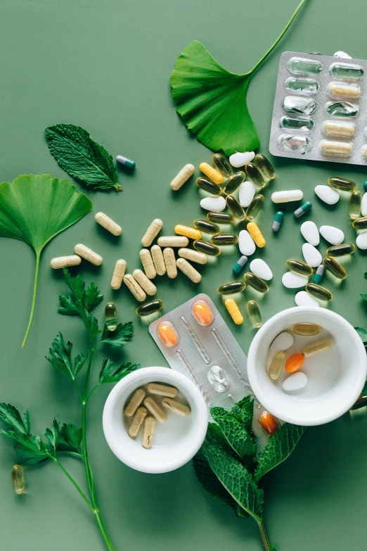 a variety of pills and capsules on a green surface, a picture, trending on pexels, renaissance, plants in beakers, leafs, thumbnail, white