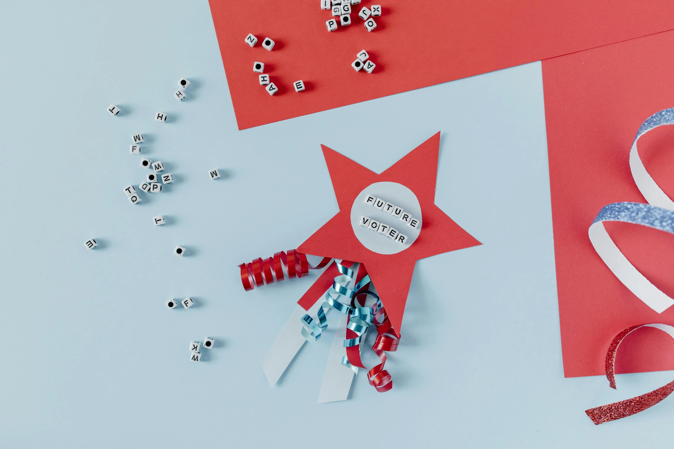 a couple of pieces of paper sitting on top of a table, inspired by Cerith Wyn Evans, pexels contest winner, teal silver red, tiny stars, detail shot, liberty curls