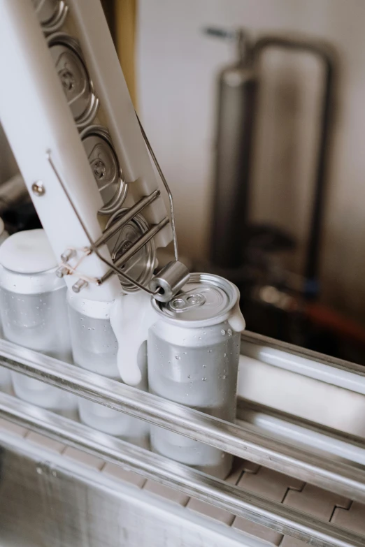 a close up of a toothbrush and toothpaste dispenser, by Adam Marczyński, pexels contest winner, process art, holding a can of beer, conveyor belts, white robot, pouring