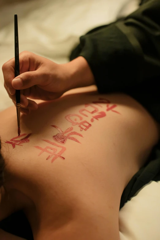 a man getting a tattoo on his back, a tattoo, inspired by Xie Huan, flickr, process art, promo image, red writing, hanfu, wētā fx