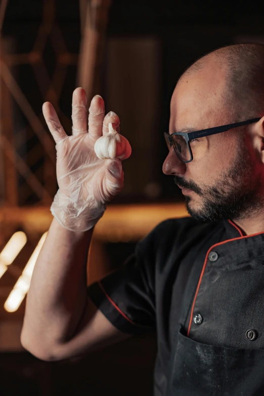 a man that is holding something in his hand, pexels contest winner, hyperrealism, dressed as a pastry chef, mozzarella, hasbulla magomedov, biohacking