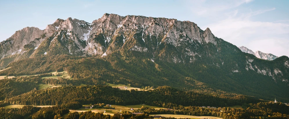 a view of the mountains from the top of a hill, by Tobias Stimmer, unsplash contest winner, chalk cliffs above, evening light, brown, slightly pixelated