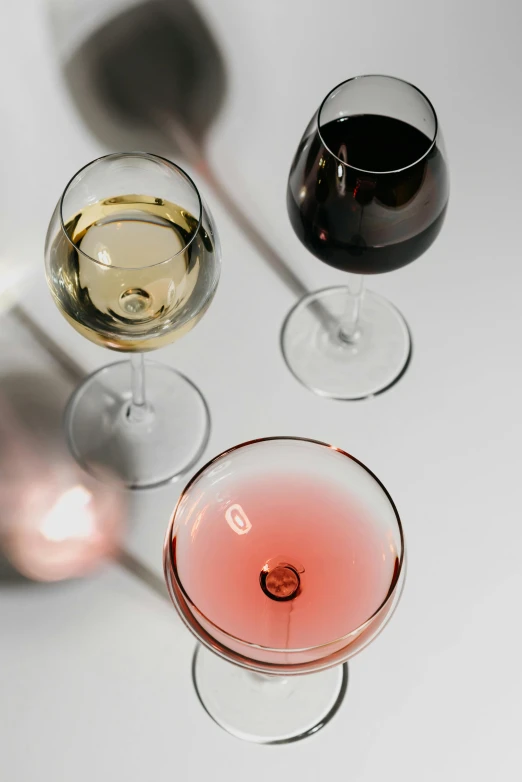 a group of wine glasses sitting next to each other, zoomed in, curated collections, product shot, with a drink