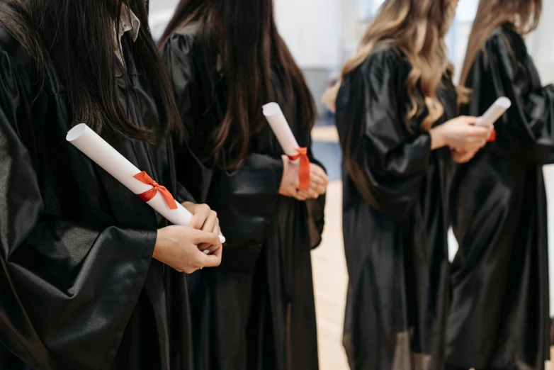 a group of women in graduation gowns holding diplomas, shutterstock, academic art, leather clothing, instagram post, black, 15081959 21121991 01012000 4k