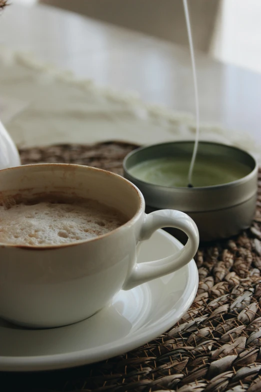 a close up of a cup of coffee on a plate, green steam rising from soup, candle, creamy skin, green tea